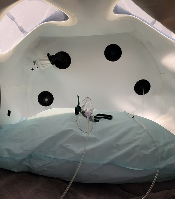 pillow and mask inside hyperbaric oxygen therapy pod